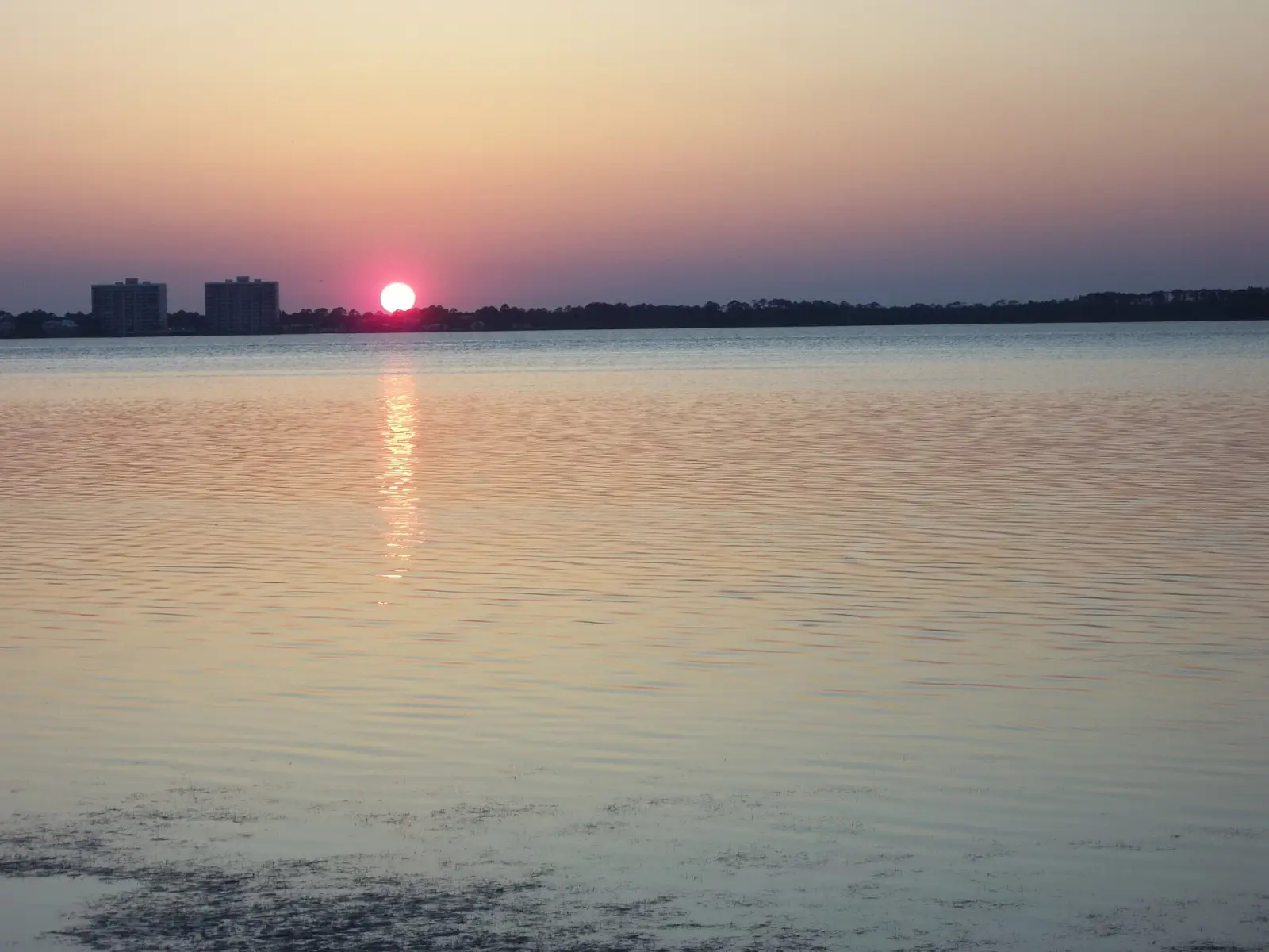 Sunset over St. Andrew Bay in Panama City, the water the Boat Parade of Lights crosses each December.