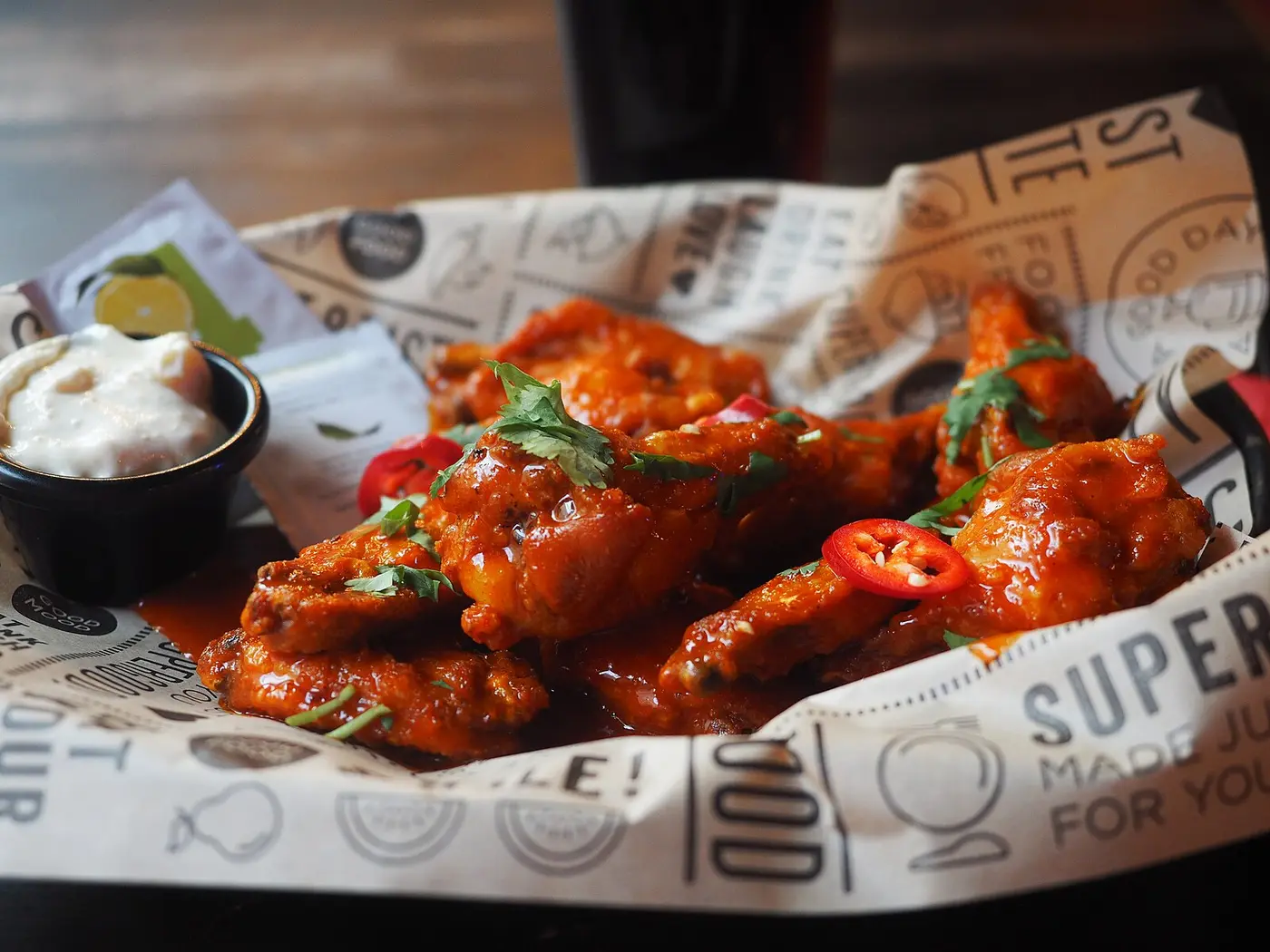 A basket of chicken wings with a dip. The photo was not taken at a Panama City restaurant.
